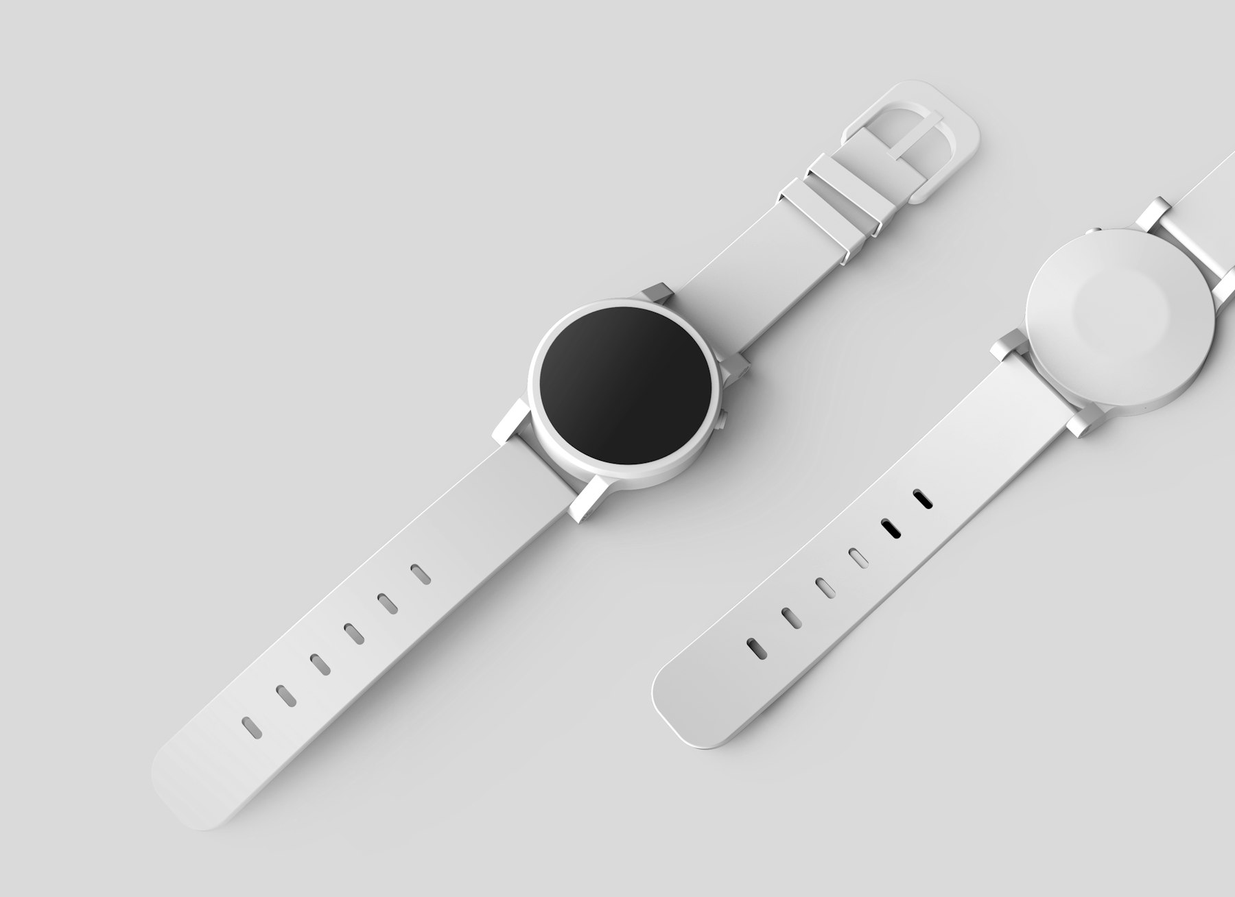 White smartwatches on a clean surface.
