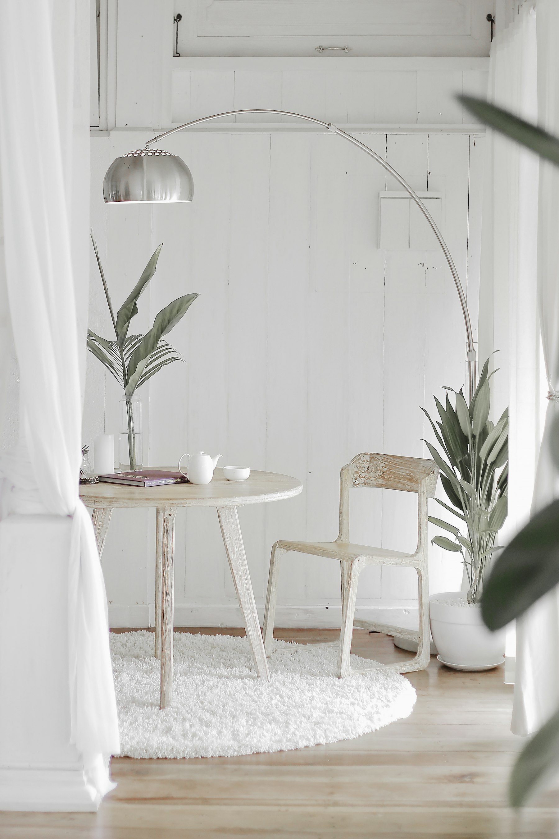 Minimal room with table and lamp.